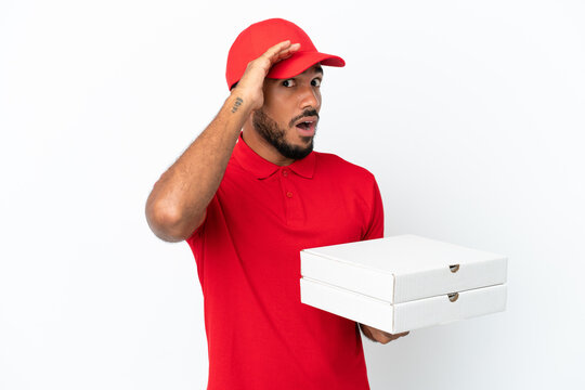 pizza delivery man picking up pizza boxes isolated on white background doing surprise gesture while looking to the side