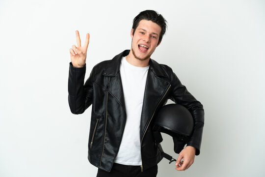 Russian man with a motorcycle helmet isolated on white background smiling and showing victory sign