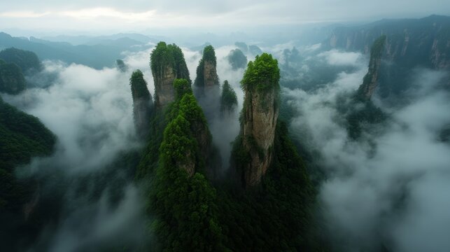 Misty Mountain Peaks: Ethereal mist weaves through towering, verdant rock formations, creating a surreal and breathtaking landscape that inspires awe and wonder.