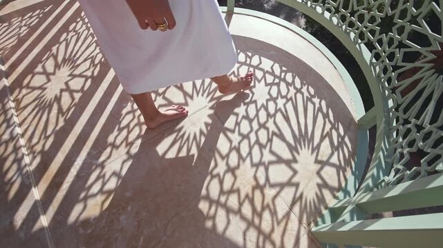 Barefoot Woman Walking Through Traditional Moroccan Geometric Shadows