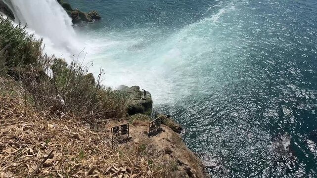 People Fishing on Rocks Below Duden Waterfall in Antalya