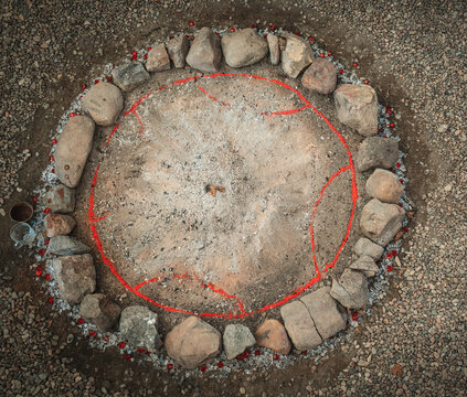 Sacred Fire Pit Decorated with Ceremonial Mandala Ornaments and Stone Circle.