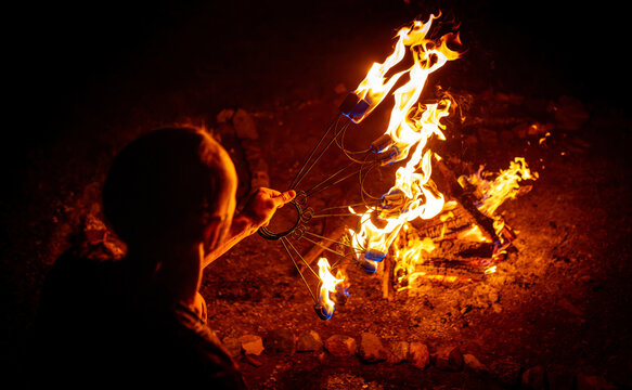 Close-up of Artist Lighting a Fire Stick at a Night Festival