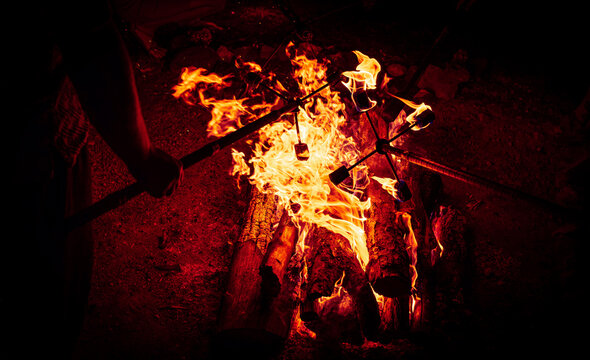 Close-up of Artist Lighting a Fire Stick at a Night Festival