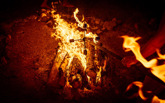 Close-up of Artist Lighting a Fire Stick at a Night Festival