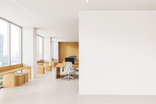 Minimalist Modern Office Interior with Wood Workstations, Ergonomic Chairs, Panoramic Windows, and Blank Wall for Design Mockup. 3D Rendering