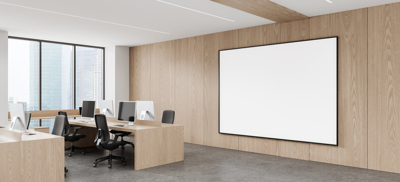 Modern Office Interior with Wood Paneling, Desks, Computers, and a Large Blank Presentation Screen Design for Collaborative Business Workspace. 3D Rendering