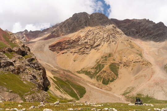 Multicolored cliffs under white clouds near Petrovsky Peak and  Lenin base camp