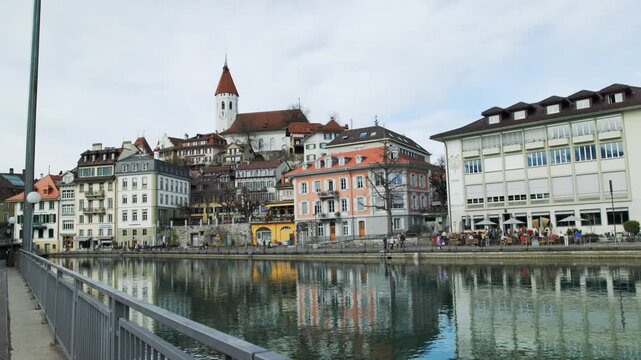Thun old town and church tower reflected in Aare river