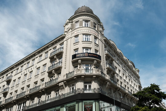 Vienna, Austria - August 18, 2025. Low angle view of the historic Hotel Astoria building facade, showcasing classic Viennese architecture with a prominent corner turret under a blue sky.