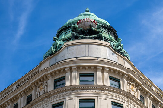 Vienna, Austria - August 18, 2025. Close-up architectural view of the historic Generali building dome, showing intricate bronze sculptures and the carved text Riunione Adriatica di Sicurta.