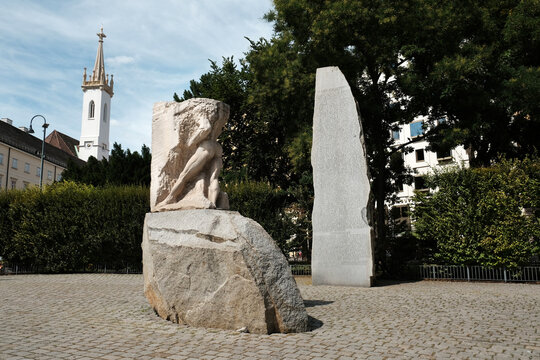 Vienna, Austria - August 18, 2025. Wide view of the Monument Against War and Fascism on Albertinaplatz, featuring the stone sculptures and the Stone of the Republic.