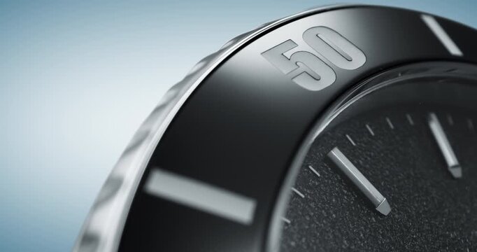 Macro close up of luxury dive watch bezel with black dial and silver markings
