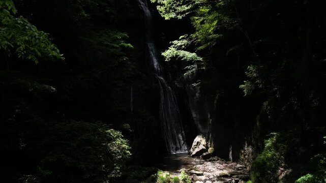 Sunlit Kanjou Falls in Mima, Tokushima, Japan &ndash; Aerial Drone View of a Waterfall Illuminated by Sunlight Filtering Through the Forest
