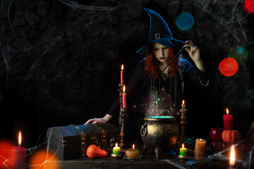 Witch with magic wand casts spell, witch's cauldron, boiling magic potion, room with candles. Young woman witchcrafting, magician girl with red hair, dressed in Halloween attire and conical hat © TSViPhoto