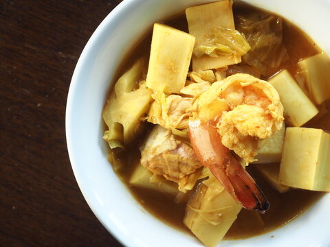 Thai spicy and sour curry with tiger prawns and young coconut shoots