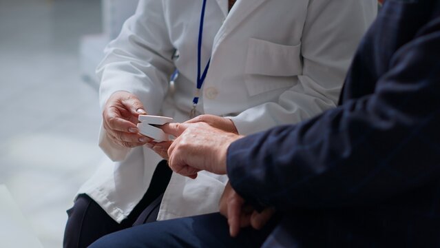 Healthcare Professional Measuring Patient Blood Oxygen Level with Pulse Oximeter