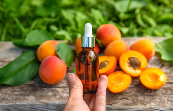 Apricot kernel oil in a bottle. Selective focus.