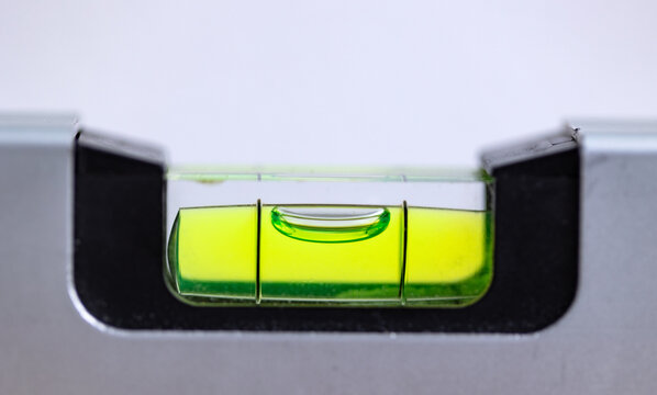 Close-up of a spirit level that is balanced. Accuracy, scale, handyman work tool, craftsman, construction industry, or carpentry.