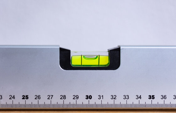 Close-up of a spirit level with a measurement scale that is level. Accuracy, scale, handyman work tool, craftsman, construction industry, or carpentry.