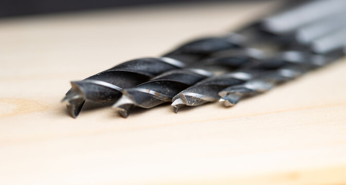 Close-up of used wood drill bits for an electric drill. Tools and equipment for woodworking and carpentry used by DIY enthusiasts, tradespeople, and in industry.