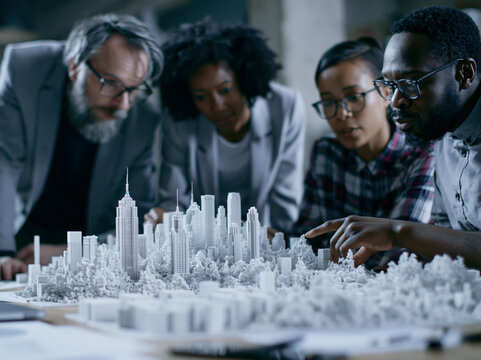 Architects and Urban Planners Examining City Architectural Model