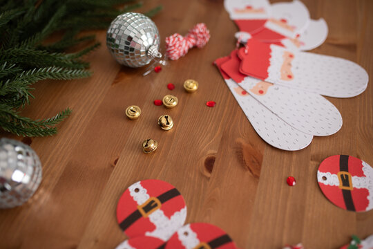 Christmas crafting supplies with Santa-themed decorations on wooden table