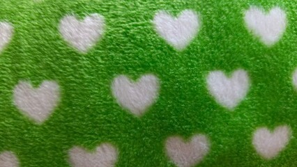 Soft Green Fleece Fabric Texture Background with White Heart Seamless Pattern Close Up © Jhaya