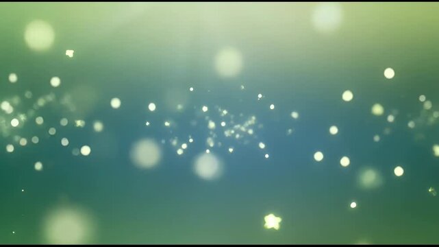 The video features a series of frames showcasing a dynamic display of glowing particles and orbs against a soft, gradient background