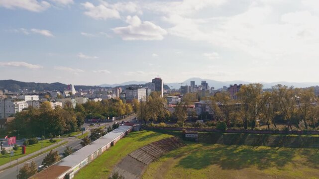 Drone captures a wide view of Ljubljana Bezigrad, the capital city of Slovenia, displaying buildings and streets under a clear sky.