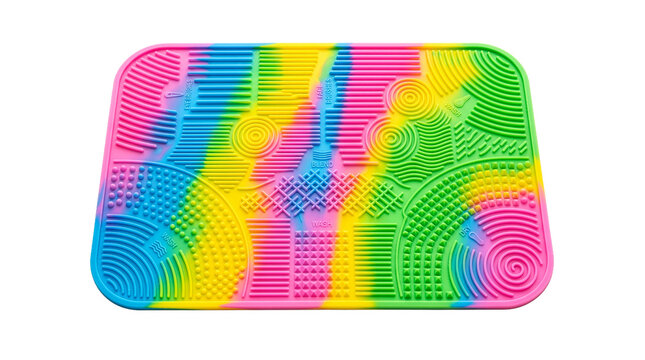 Colorful silicone makeup brush cleansing pad with textured surface, isolated on white background