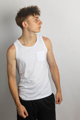 Obraz premium Teenage boy in Sleeveless top and black shorts