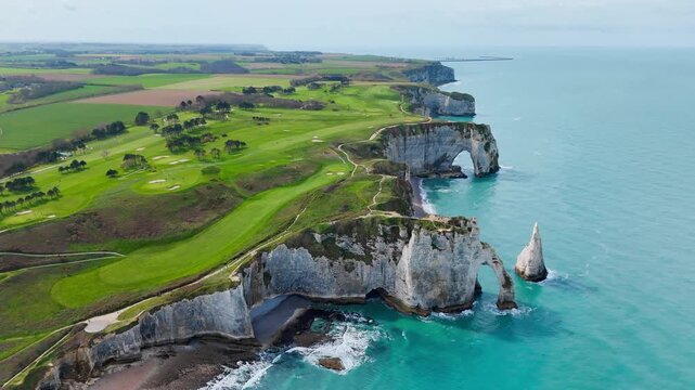 Chalk cliffs and erosional landforms in Normandy, France. Natural arch and sea stack dominate coastal geology scene