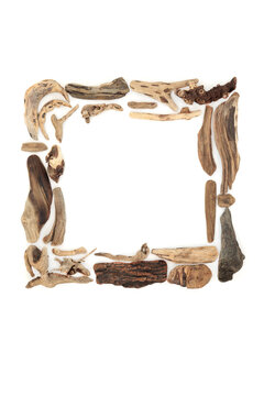 Rustic driftwood square shape frame sculpture on white background. Natural beach, coastal and seaside art for greeting card. Copy space.