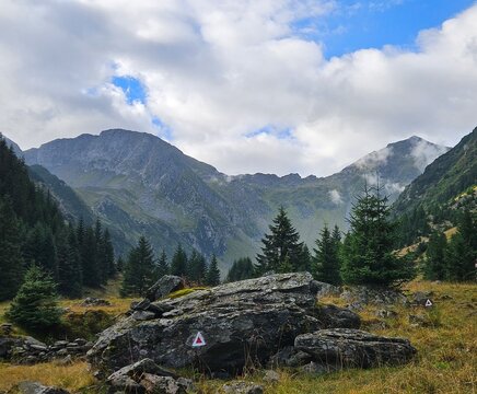 Fagaras Mountains alpine landscape with a hiking trail marker.
