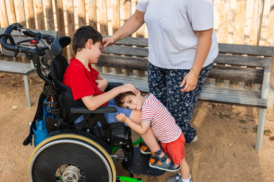 Little boy hugging brother with cerebral palsy
