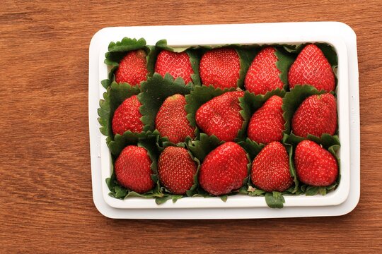 Fresh RIpe Red Strawberry on White Plastic Packaging