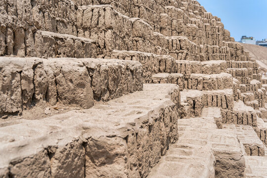 The complex, terraced adobe brick construction of the ancient Huaca Pucllana pyramid in the Miraflores district of Lima