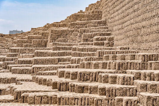 The complex, terraced adobe brick construction of the ancient Huaca Pucllana pyramid in the Miraflores district of Lima