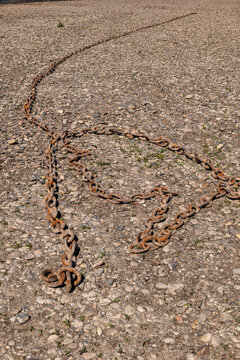 Rusty Mooring Chain On River shore