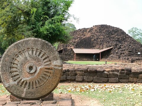 Stone Dharmachakra and Ancient Ruins at Si Thep Historical Park