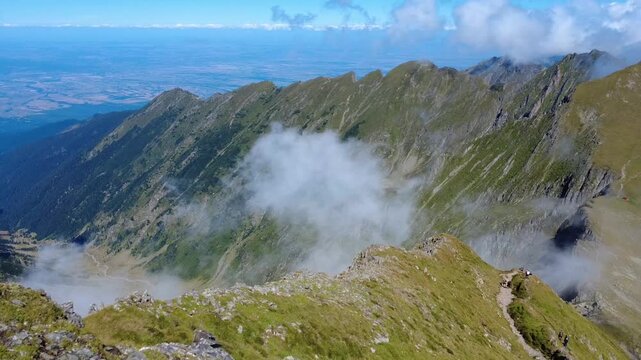 Majestic mountain landscape with moving clouds and deep valleys.