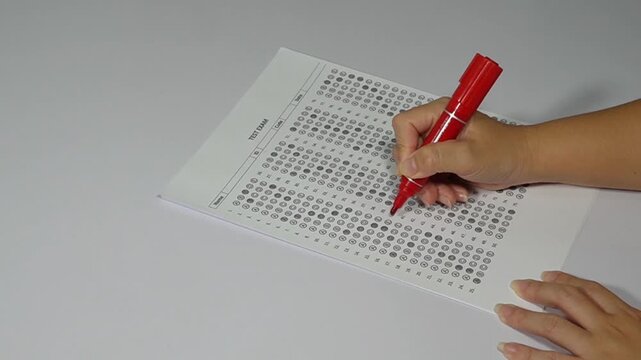Education and assessment concept, teacher grading student exam with top mark.