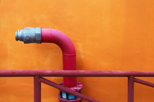 Red fire hydrant in an outdoor industrial area. Place for text.