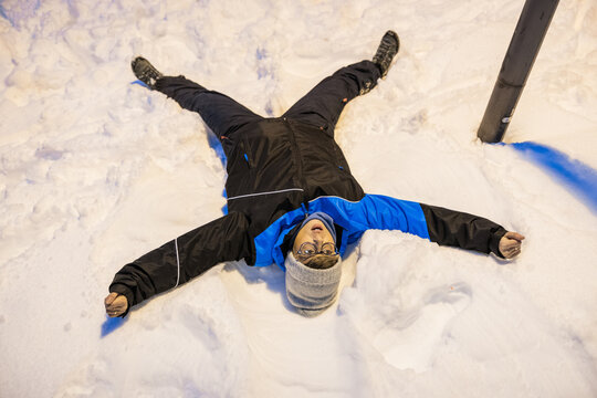 Person making a snow angel in winter wonderland