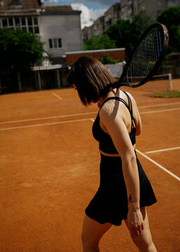 Young woman playing tennis on clay court