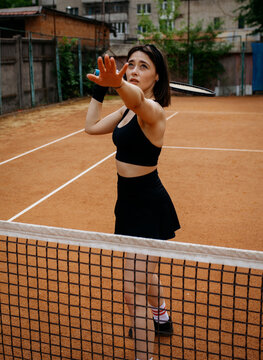 Young woman playing tennis on clay court