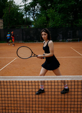 Young woman playing tennis on clay court