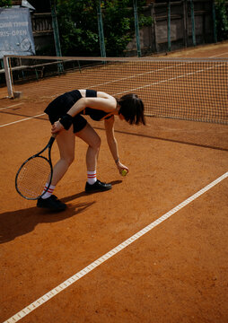 Young woman playing tennis on clay court