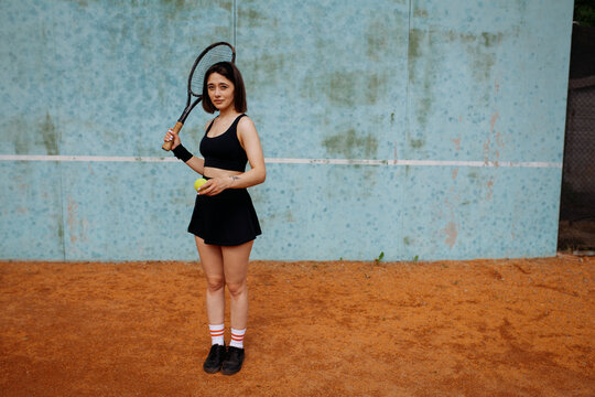 Young woman playing tennis on clay court